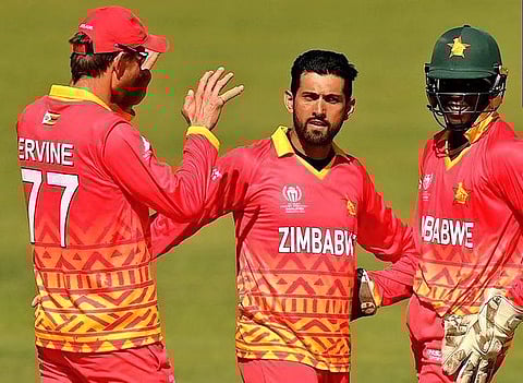 Sikandar Raza celebrates a wicket with teammates during a Cricket World Cup Group A qualifier match against the Netherlands on Tuesday.