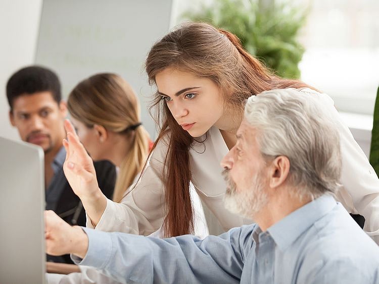 Stock - Boomer and millennial in office