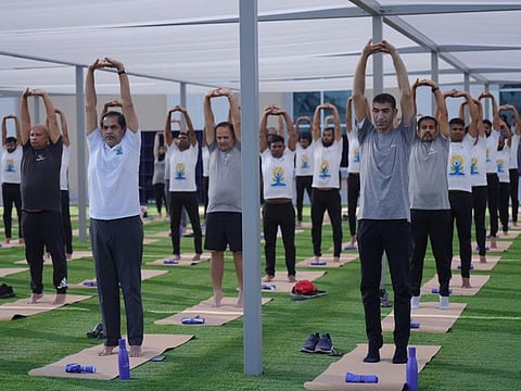 Dr Thani bin Ahmed Al Zeyoudi, Minister of State for Foreign Trade (1st R) and Ambassador of India Sunjay Sudhir (2nd R) during the Ocean Ring of Yoga event held at the DP World Cruise Terminal of the Port Rashid in Dubai as part of the International Yoga Day celebrations on Wednesday. 