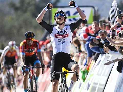 UAE Team Emirates' rider Tadej Pogacar celebrates as he crosses the finish line during the 'La Fleche Wallonne' cycling race in April.