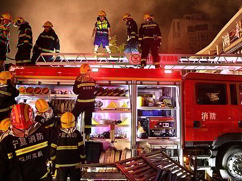 Firefighters work at the site of an explosion at a restaurant in Yinchuan, northwest China's Ningxia Hui Autonomous Region. 