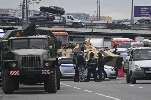 An armoured personnel carrier and police officers on a highway on the outskirts of Moscow, on June 24, 2023. 