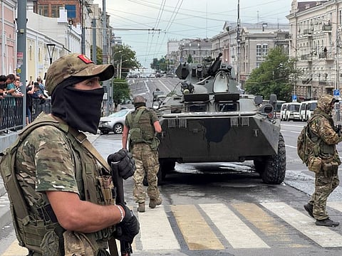 Fighters of Wagner private mercenary group stand guard in a street near the headquarters of the Southern Military District in the city of Rostov-on-Don, Russia, June 24, 2023.  