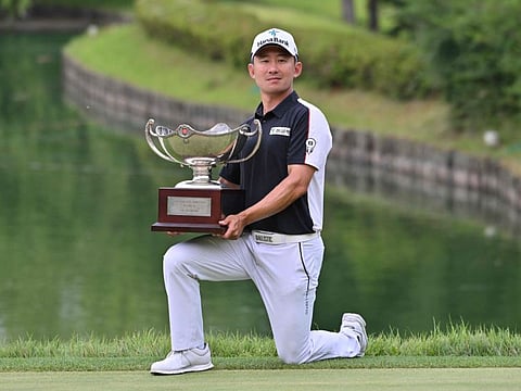 USA's Seungsu Han poses with the trophy after his victory in the Kolon Korea Open golf championship at Woo Jeong Hills Country Club in Cheonan on Sunday.