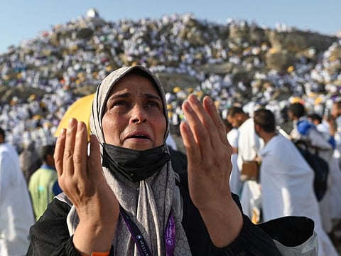 A pilgrim prays atop Saudi Arabia's Mount Arafat, also known as Jabal Al Rahma or Mount of Mercy, during the climax of the Hajj pilgrimage.  