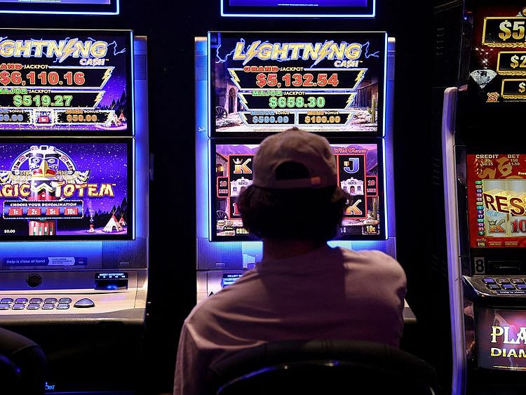 A person gambles on a poker machine at a pub in Sydney, Australia, September 19, 2022.   