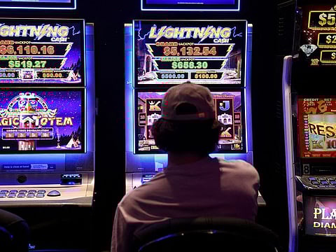 A person gambles on a poker machine at a pub in Sydney, Australia, September 19, 2022.   