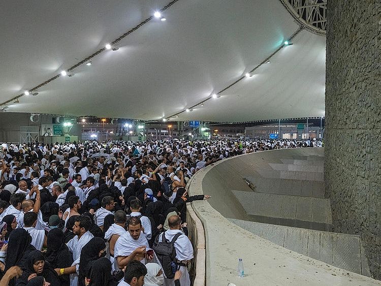 Pilgrims cast their stones at a pillar symbolising the stoning of Satan in Mina on June 28, 2023.  