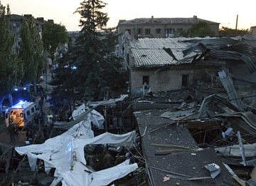 In this photo provided by the National Police of Ukraine, people clear the rubble in a restaurant RIA Pizza destroyed by a Russian attack in Kramatorsk, Ukraine, Tuesday, June 27, 2023.  