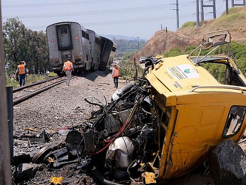 A destroyed truck lies next to a derailed Amtrak train in Moorpark, Calif., on Wednesday, June 28, 2023. 