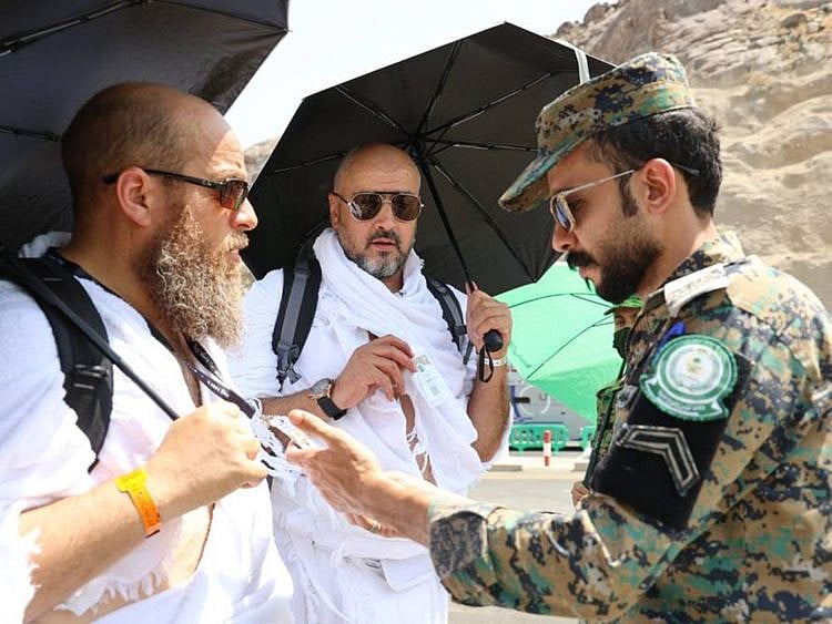 Security authorities check pilgrims’ permit at entrances to Mecca.  