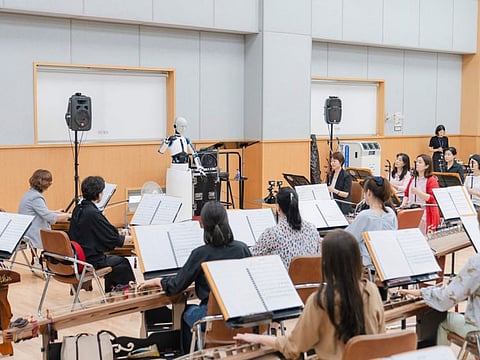 This handout picture taken on June 26, 2023 and provided by the National Theater of Korea shows the South Korean-made robot called "EveR 6" conducting musicians of the National Orchestra of Korea during a practice session at the national theatre in Seoul.  