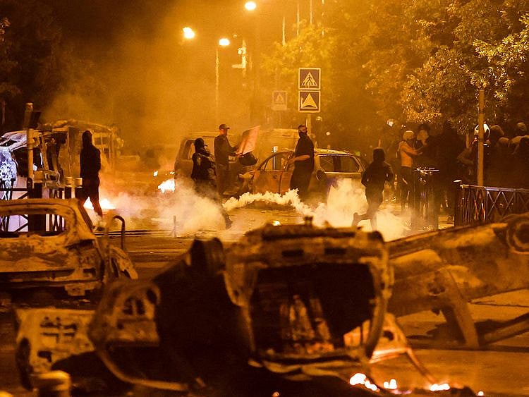 Protesters clash with police after burning vehicles, following the death of Nahel, a 17-year-old teenager killed by a French police officer during a traffic stop, in Nanterre, Paris suburb, France, June 30, 2023.  