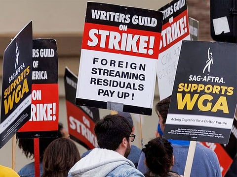 File photo: Members of SAG-AFTRA and the Writers Guild of America walk the picket line outside Paramount Studios in Los Angeles, California, on June 7, 2023. 