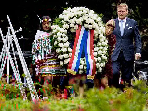 Dutch King Willem-Alexander lays a wreath at the slavery monument after apologising for the royal house's role in slavery and asked forgiveness in a speech greeted by cheers and whoops at an event to commemorate the anniversary of the country abolishing slavery in Amsterdam, Netherlands, Saturday, July 1, 2023.  
