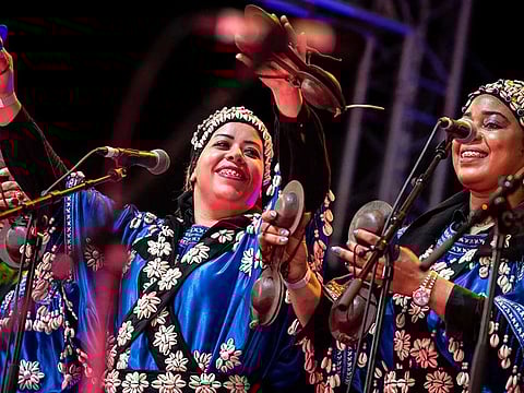 This photo taken on June 24, 2023 shows female members of traditional Gnawa bands performing during the 24th edition of the Gnaoua World Music Festival in Essaouira. 