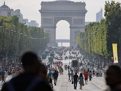  Pedestrians walk on Champs-Elysees avenue in Paris, on July 2, 2023, a day after protesters took to the street and clashed with police on an iconic street popular with tourists during a protest against the police killig of a 17-year-old teenage boy. 