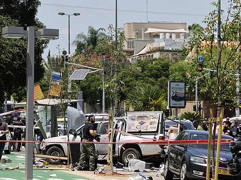  Israeli security personnel work at the scene of a ramming attack in Tel Aviv, Israel July 4, 2023. 