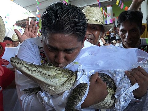 Victor Hugo Sosa, Mayor of San Pedro Huamelula, kisses a spectacled caiman (Caiman crocodilus) called "La Niña Princesa" ("The Princess Girl") before marrying her in San Pedro Huamelula, Oaxaca state, Mexico.