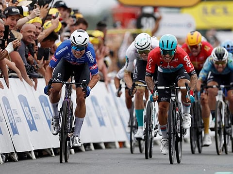 Alpecin–Deceuninck's Jasper Philipsen in action before he crosses the finish line to win stage 4 alongside second placed Lotto–Dstny's Caleb Ewan on Tuesday.