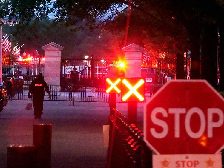 Police are seen outside the White House grounds in Washington
