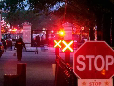 Police are seen outside the White House grounds in Washington. The White House was briefly evacuated Sunday evening after the Secret Service discovered suspicious powder in a common area of the West Wing.   