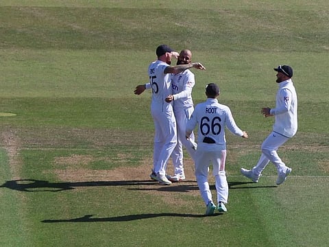England's Moeen Ali celebrates with Ben Stokes, Joe Root and Ben Duckett after taking the wicket of Australia's Marnus Labuschagne.