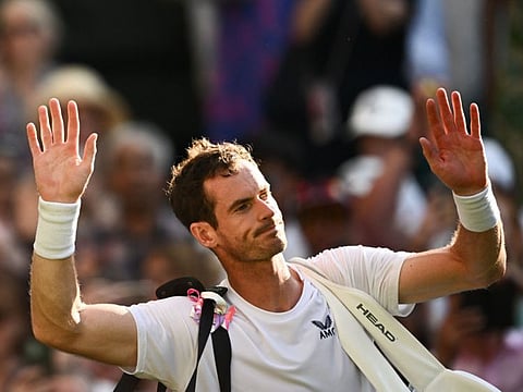 Britain's Andy Murray waves to the public as he leaves Centre Court following his defeat against Greece's Stefanos Tsitsipas.