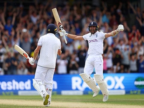 England's Chris Woakes and Mark Wood celebrate after winning the third Test against Australia at Headingley Cricket Ground, Leeds, on Sunday.