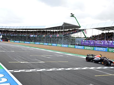 Red Bull's Max Verstappen takes the chequered flag to win the British Grand Prix race in Silverstone Circuit, Silverstone on Sunday