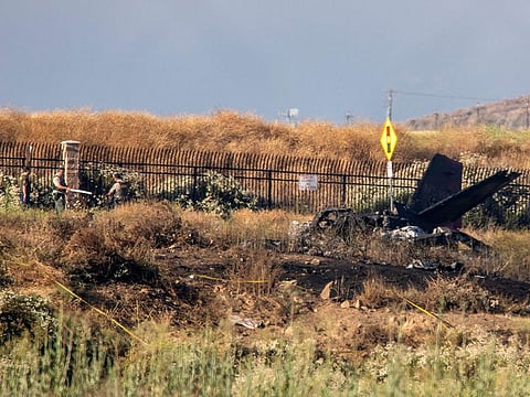 Charred remains of a Cessna lie near the landing approach at French Valley Airport, in Murrieta, Calif., Saturday, July 8, 2023. 