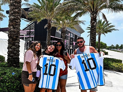 Fans of Argentine football player Lionel Messi pose for a photo while waiting for his arrival at the DRV PNK Stadium in Fort Lauderdale, Florida, on July 11, 2023.  