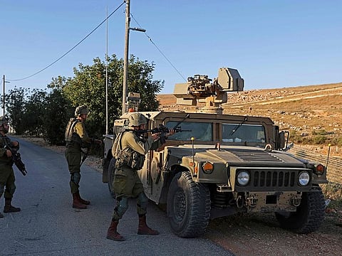 Israeli soldiers take position along border with Lebanon, in the town of Metulla in northern Israel on July 12, 2023.  