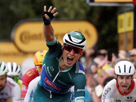 Alpecin–Deceuninck's Jasper Philipsen celebrates as he crosses the finish line to win Stage 11 on Wednesday.