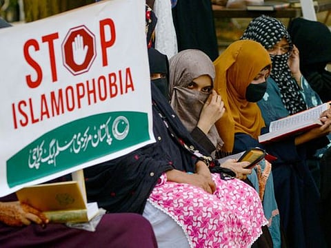 Activists and supporters of Pakistan Markazi Muslim League (PMML) party read the Quran during an anti-Sweden demonstration in Karachi on July 9, 2023.