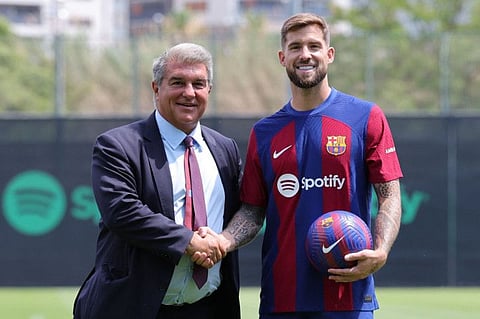 Barcelona's newly signed Spanish defender Inigo Martinez (right) poses with Barcelona's President Joan Laporta during his official presentation at the Joan Gamper training ground in Sant Joan Despi on Thursday.