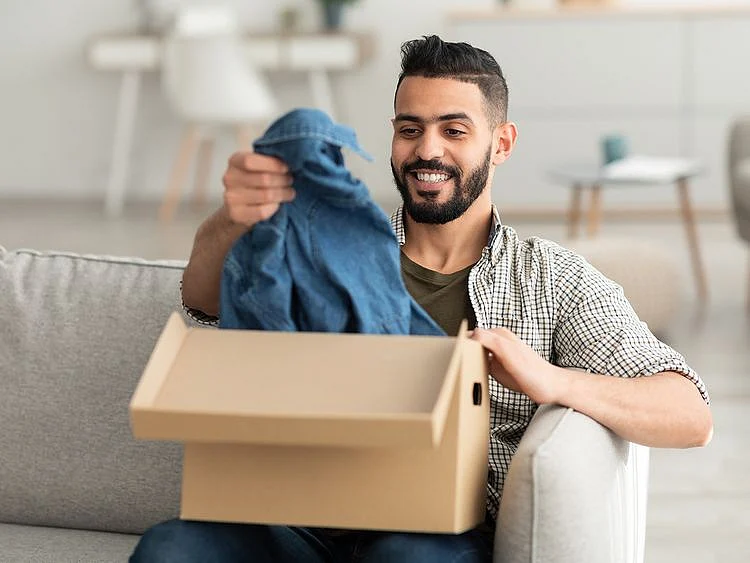 Person opening new box of clothes