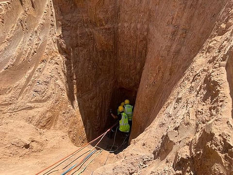 Civil defence personnel work inside a well parallel to the one where the man was trapped. 