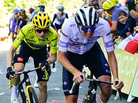 UAE Team Emirates' Tadej Pogacar wearing the best young rider's white jersey cycles ahead of Jumbo-Visma's Jonas Vingegaard.