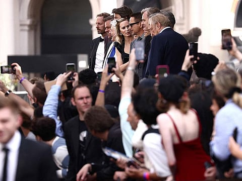The cast of "Oppenheimer" including British actress Emily Blunt, US actor Robert Downey Jr, US actor Matt Damon, Irish actor Cillian Murphy and British actress Florence Pugh pose together after walking out early of the UK premiere of "Oppenheimer" in central London on July 13, 2023 in solidarity with Hollywood actors' union strike.   