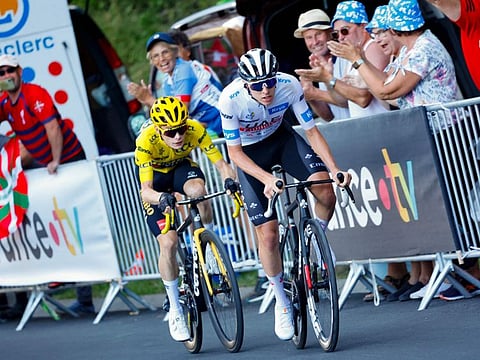 UAE Team Emirates' Slovenian rider Tadej Pogacar wearing the best young rider's white jersey cycles ahead of Jumbo-Visma's Danish rider Jonas Vingegaard wearing the overall leader's yellow jersey in the final ascent of Saint-Gervais-les-Bains in the last kilometers of the 15th stage of the Tour de France race in the French Alps on Sunday.