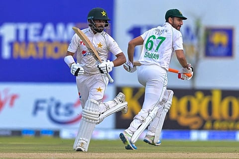 Pakistan's Agha Salman (right) and Saud Shakeel run between the wickets during the second day of the first Test against Sri Lanka at the Galle International Cricket Stadium in Galle on Monday.