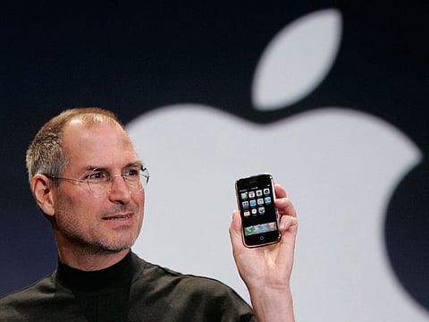 Apple CEO Steve Jobs holds up an Apple iPhone at the MacWorld Conference, Jan. 9, 2007, in San Francisco. 