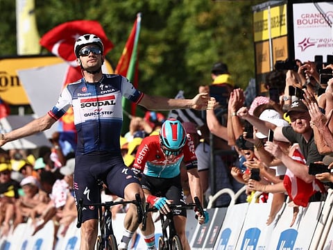 Soudal Quick-Step's Danish rider Kasper Asgreen cycles to the finish line ahead of Lotto Dstny's Dutch rider Pascal Eenkhoorn to win the 18th stage of the 110th edition of the Tour de France cycling race in the French Alps on Thursday.