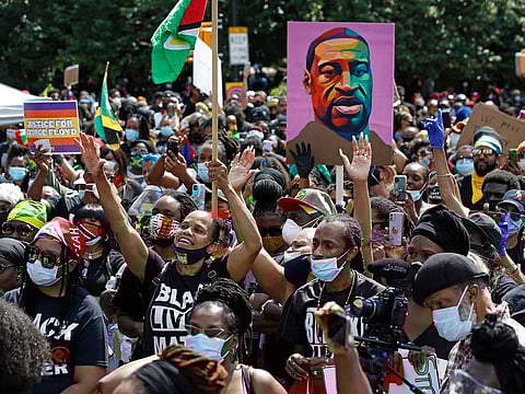 People participate in a Caribbean-led Black Lives Matter rally on June 14, 2020, at Brooklyn's Grand Army Plaza in New York