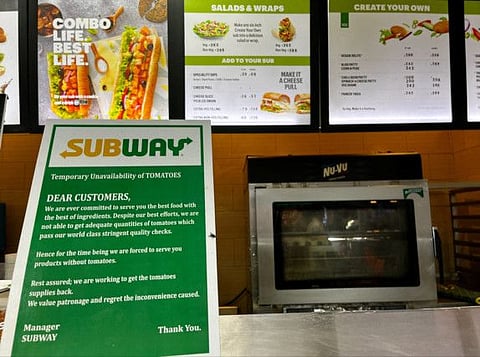 A notice on the temporary unavailability of tomatoes is seen at a Subway outlet at an airport terminal in New Delhi.