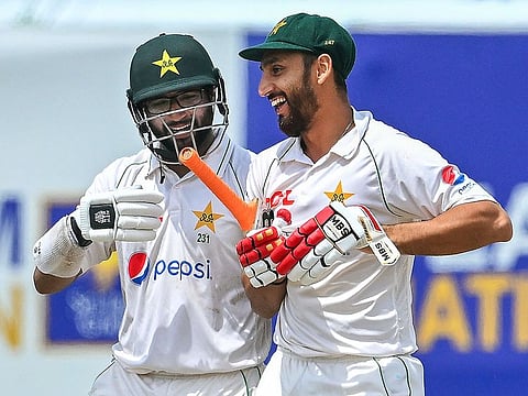 Pakistan's Imam-ul-Haq (L) and Agha Salman walk back to the pavilion after Pakistan won by 4 wickets on the fifth and final day of play of the first Test match against Sri Lanka at the Galle International Cricket Stadium in Galle on July 20, 2023. 
