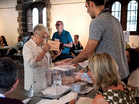 A woman casts her ballot during Spain's general election, in Elgoibar on July 23, 2023.  