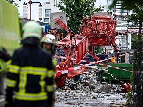 Firemen work next to a construction crane that collapsed during a violent storm that hit La Chaux-de-Fonds, northwestern Switzerland.