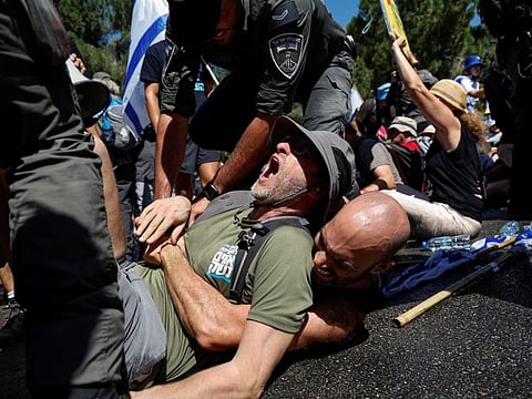 Israeli security forces clash with protesters during a demonstration against Israeli Prime Minister Benjamin Netanyahu and his nationalist coalition government's judicial overhaul, in Jerusalem July 24, 2023.  